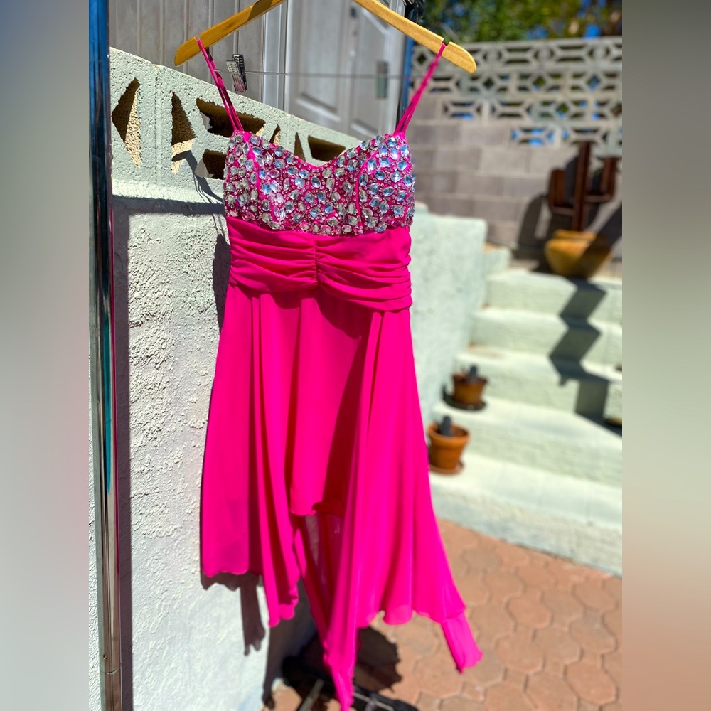 Spaghetti strap, tiered pink gown adorned with silver crystals. Zip up back.